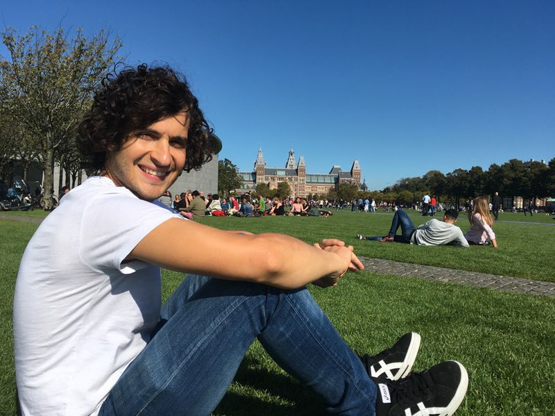 Sitting on the lawn at Museumplein with the Rijksmuseum in view